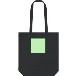 A black tote bag featuring a square area in a light green colour. The bag has two shoulder straps and a logo.