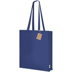 A navy tote bag with long handles and a tag, featuring a simple, sleek design.