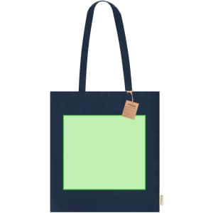 A navy blue tote bag with a large green rectangular design and a tag attached.