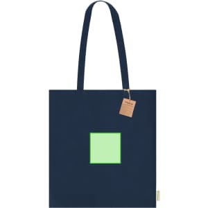 A navy tote bag featuring a green square design and a brand tag attached.