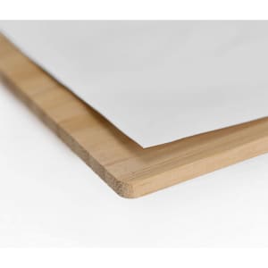 A bamboo organiser with a smooth edge and a sheet of paper partially covering it. Features neutral tones.