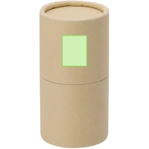 A cylindrical kraft paper container with a green label, holding a set of crayons.