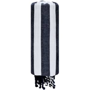 A navy and white striped bath towel with tassels, featuring a branding logo.