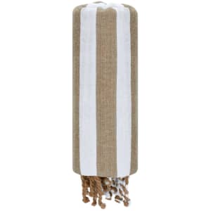 A striped towel pareo in brown and white with decorative tassels at one end, featuring a logo.