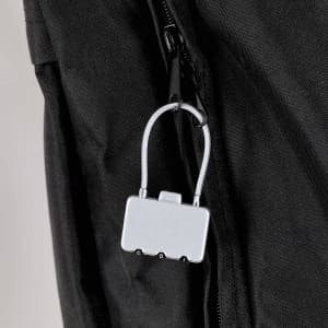 A silver padlock attached to a black fabric bag, featuring a simple design and a clip for easy attachment.