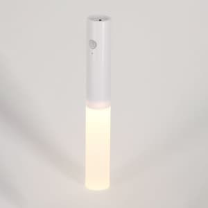 A white torch with a cylindrical design, featuring a light beam at one end and a button on the side.