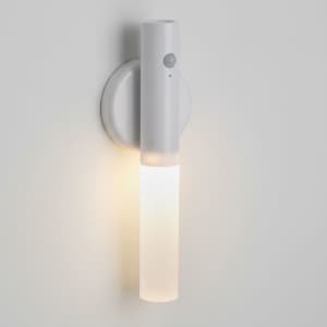 A white LED torch mounted on a wall, featuring a modern design with a translucent light section and a small logo.