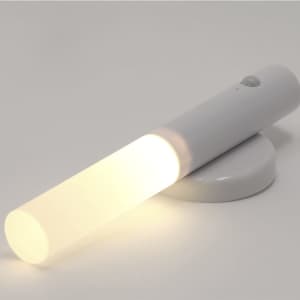 A white torch with a cylindrical design, emitting a soft white light, placed on a round base. It has a logo.