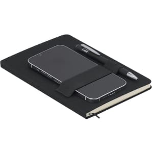 A black notepad with a smartphone held in place by an elastic strap and accompanied by a pen.