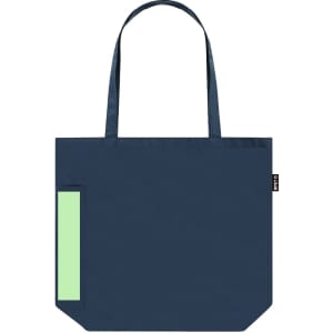 A navy tote bag with a large front pocket in pastel green and sturdy shoulder straps. It features a logo tag.