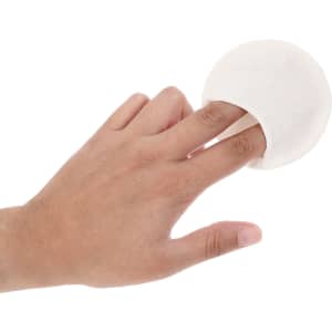 A white facial cleansing pad with a finger insert, demonstrating its soft texture and design for personal use.