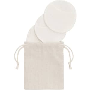 A set of four white facial cleansing pads packaged in a small beige drawstring bag.