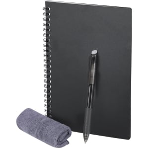 A black spiral-bound notebook with a pen and a grey cleaning cloth placed beside it. The notebook has a logo.