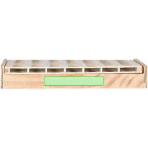 A wooden game board with a light green label, featuring multiple cut-out slots for game pieces.