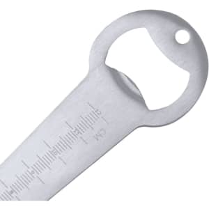 A drink bottle opener in silver, featuring a gauge for measuring seed depth. Includes a branding logo.