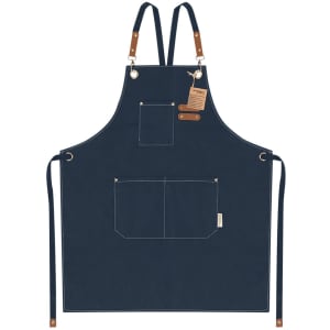 A navy blue apron with adjustable straps, featuring pockets and leather accents, plus a branded tag.