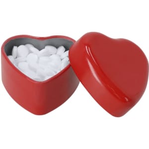 A heart-shaped red candy dispenser filled with white mints, featuring a smooth, glossy finish.