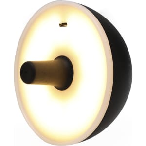 A round lamp featuring a white glow with a black and gold design, complete with a logo.