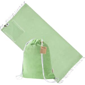 A light green drawstring bag accompanied by a matching towel or pareo, featuring a pocket and frayed edges.