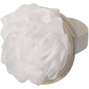 A white exfoliating sponge with a textured surface and a flower design, featuring a soft elastic band.