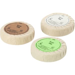 Three circular soap bars wrapped in eco-friendly paper, featuring brown, green, and white colours. Each bar weighs 200g.