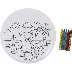 A round, colourable frisbee featuring a bear at the beach scene, accompanied by a set of crayons in various colours.