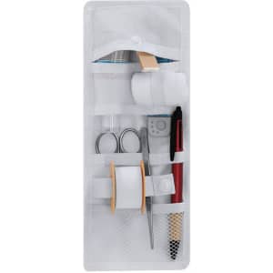A white nursing organiser containing scissors, tape, a pen, cotton rolls, and other medical supplies.