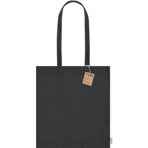 A black tote bag with two handles and a tag, featuring a plain design and a branding logo.