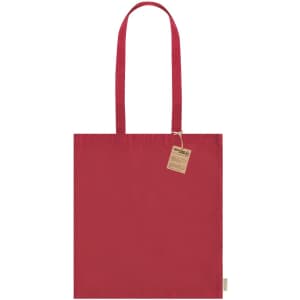 A red tote bag with two shoulder straps and a small tag attached. The bag features a branding logo.