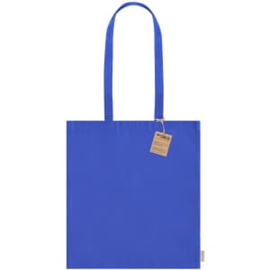 A blue tote bag with two handles and a tag. The bag has a simple and clean design.