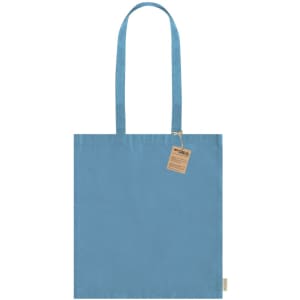 A blue tote bag with long handles and a tag attached. The bag has a simple, solid colour design.
