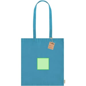 A bright blue tote bag with a green square design and a tag attached, featuring an unmarked logo.