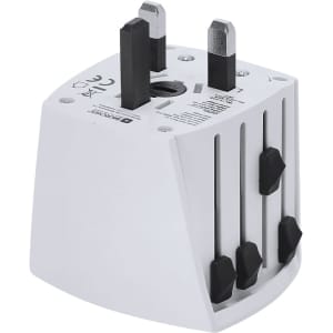 A white universal travel adapter with adjustable prongs and a logo on the side.