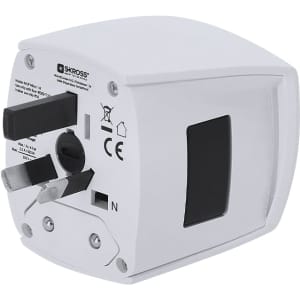 A white universal travel adapter with multiple plug options and a logo on the side.