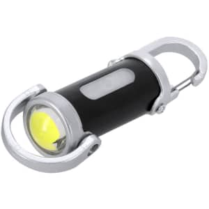 A black and silver torch with a yellow light and a carabiner for easy attachment. It features a sleek, cylindrical design.