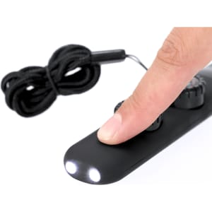 A black survival whistle with two white LED lights, featuring a finger pressing on its surface and a cord attached.