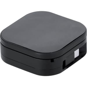 A black charging cable holder with a sleek, square design and a concealed compartment for organisation.