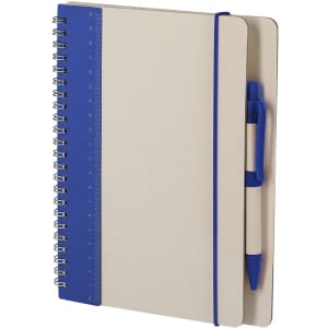 A spiral-bound notebook with a cream cover and blue accents, featuring a ruler and a blue pen attached.