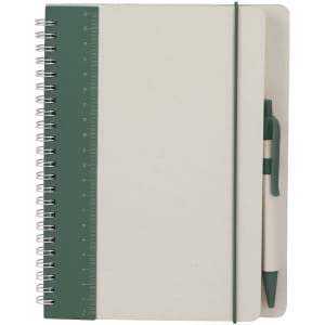 A green and cream Kirax Notebook with a ruler, spiral binding, and a matching pen. It features a branding logo.