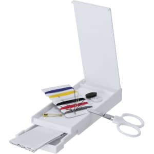 A white sewing kit containing thread, needles, scissors, buttons, and a safety pin, neatly organised in an open case.