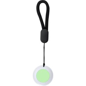 A round, white tracker with a green centre, featuring a black strap for attachment.