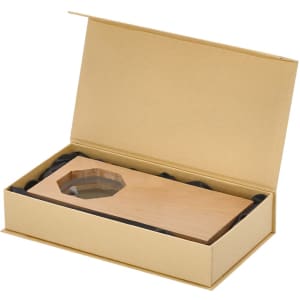 A golden gift box containing a wooden plaque with a transparent section, nestled in black cushioning.