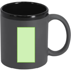 A coffee mug in matte black with a green rectangular area. It has a handle and a glossy interior.