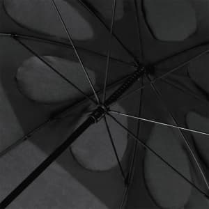 A black umbrella viewed from underneath, showing the structure and fabric detailing. It has a logo on the handle.