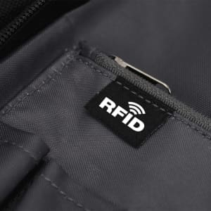 A close-up of a black fabric interior featuring a zippered pocket with an RFID tag. The fabric has a grey hue.