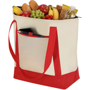 A cream cooler bag with red straps, filled with fruits, snacks, and a drink bottle, featuring a pocket and pen.