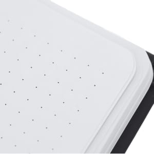 A notepad with a white dotted surface and a black cover, featuring rounded corners and a logo.