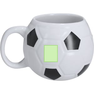 A coffee mug shaped like a soccer ball, featuring black and white patches. It has a handle and a smooth interior.