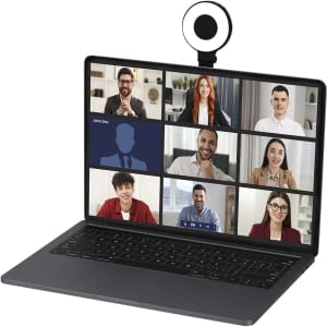 A laptop with a black webcam attached, displaying a video call grid with nine participants.