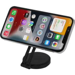 A smartphone propped up on a black stand, displaying various app icons on the screen.